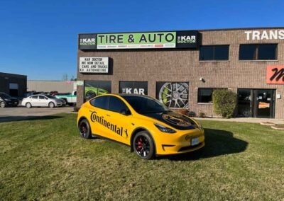Yellow Tesla out front of the Kar Doctor - Car repair London Ontario